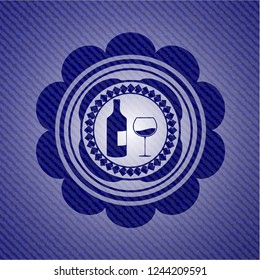 bottle and glass of wine icon inside emblem with jean texture
