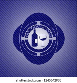 bottle and glass of wine icon inside badge with denim background