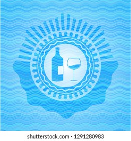 bottle and glass of wine icon inside water wave emblem.