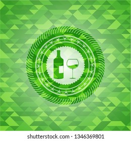 bottle and glass of wine icon inside green emblem with mosaic background