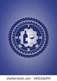 bottle and glass of wine icon inside emblem with denim high quality background