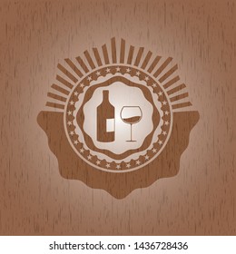 bottle and glass of wine icon inside wood badge or emblem