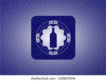 bottle icon inside badge with denim background
