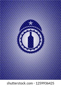 bottle icon inside emblem with denim high quality background
