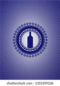 bottle icon inside emblem with jean texture