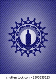 bottle icon inside emblem with jean texture