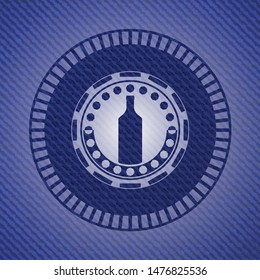 bottle icon inside emblem with jean background