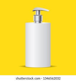 bottle of liquid soap with metal pump isolated on yellow background