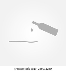 bottle and spoon on gray gradient background