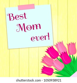 Bouquet of seven pink tulips, a sticker with text on the background of a yellow wood texture. Congratulations. Mothers Day.