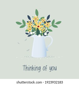 Bouquet of spring flowers in ceramic milk jug. Thinking of you text.