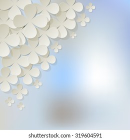 Bouquet of white flowers in the corner on a light blue bokeh fog background.