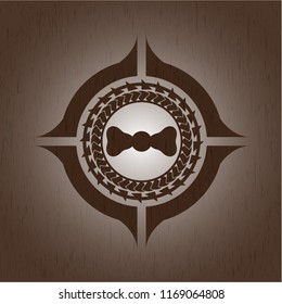 bow tie icon inside badge with wooden background
