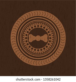 bow tie icon inside badge with wood background