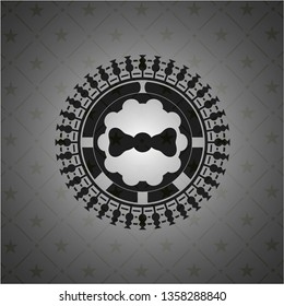 bow tie icon inside black emblem