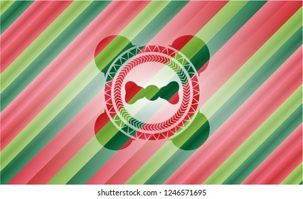 bow tie icon inside christmas colors badge.