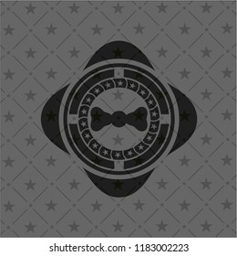 bow tie icon inside dark badge or emblem