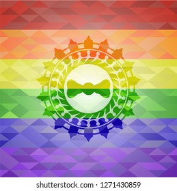 bow tie icon inside emblem on mosaic background with the colors of the LGBT flag
