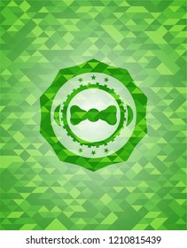 bow tie icon inside green emblem with mosaic ecological style background