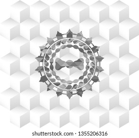 bow tie icon inside grey emblem with cube white background