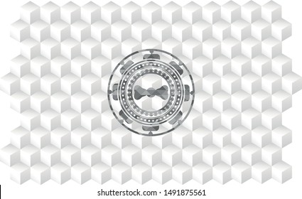 bow tie icon inside grey badge with geometric cube white background
