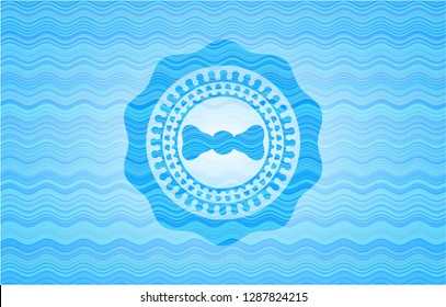 bow tie icon inside light blue water wave style badge.