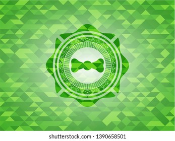 bow tie icon inside realistic green mosaic emblem