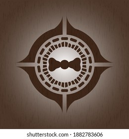 bow tie icon inside realistic wood emblem. 