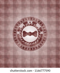 bow tie icon inside red seamless emblem with geometric pattern background.