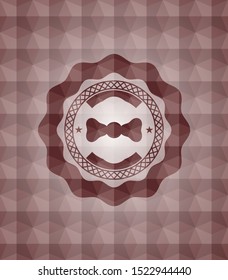 bow tie icon inside red seamless emblem with geometric pattern.
