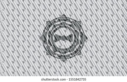 bow tie icon inside silver shiny badge. Scales pattern. Vector Illustration. Detailed.
