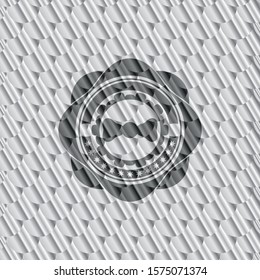 bow tie icon inside silver badge or emblem. Scales pattern. Vector Illustration. Detailed.