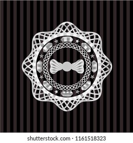 bow tie icon inside silvery emblem or badge