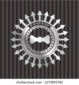 bow tie icon inside silvery emblem or badge
