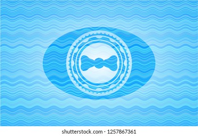 bow tie icon inside water concept badge background.