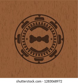 bow tie icon inside wooden emblem. Vintage.