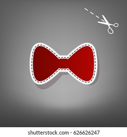 Bow Tie icon. Vector. Red icon with for applique from paper with shadow on gray background with scissors.