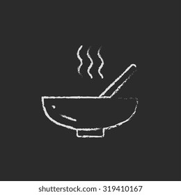 Bowl of hot soup with spoon hand drawn in chalk on a blackboard vector white icon isolated on a black background.