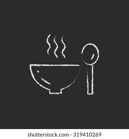 Bowl of hot soup with spoon hand drawn in chalk on a blackboard vector white icon isolated on a black background.