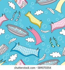 A bowl of soapy water, clean linen on a rope, washing powder and an iron on a background of blue sky, clouds and soap bubbles
