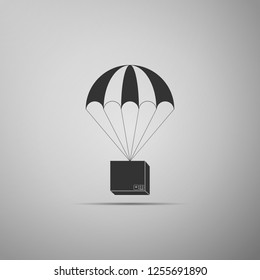 Box flying on parachute icon isolated on grey background. Parcel with parachute for shipping. Delivery service, air shipping concept, bonus concept. Flat design. Vector Illustration