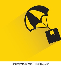 box and parachute with drop shadow on yellow background