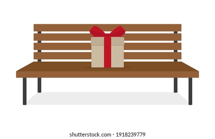 Una caja con un arco rojo sobre un banco de madera de fondo blanco