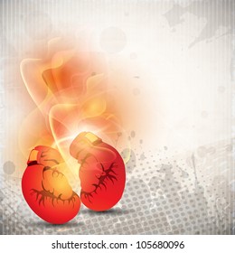 Boxing gloves in fire on grungy dotted grey background. EPS 10.