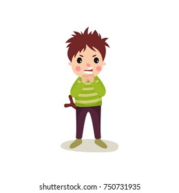 Boy with angry face standing with slingshot in back pocket