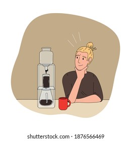 Boy barista waiting for black filtered coffee to brew in coffeeshop
