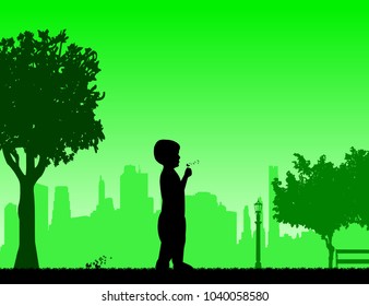Boy blowing the dandelion in park under the tree silhouette, one in the series of similar images