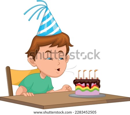 boy blowing out candles on birthday party