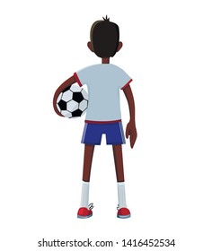 The boy in the blue T-shirt is standing with a soccer ball in his hand.