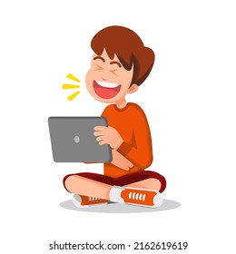 a boy bursts into laughter while watching on his tablet